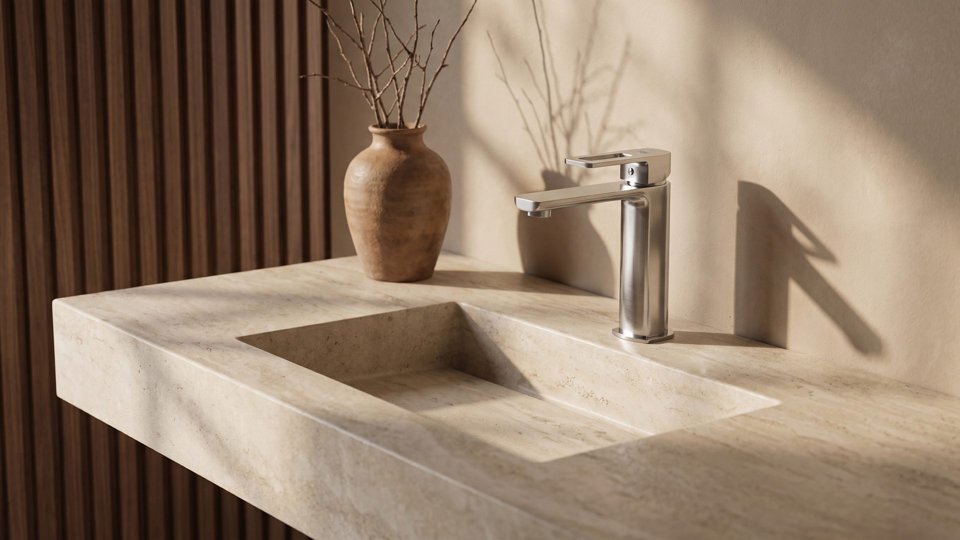 Lavish basin mixer on a carved travertine vanity